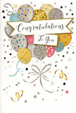 The photograph shows a tall, elegant congratulations card, its front artwork filled with a floating bouquet of balloons that suggest a moment of pure celebration in Harlesden. The design centres on a cluster of overlapping balloons, each drawn with gentle curves and soft shading to give a sense of depth, as though they are drifting upward from the bottom of the card. The colours are sophisticated yet joyful: muted gold, cool silver, champagne, light sky blue, blush pink, and soft grey all blend together seamlessly, reminiscent of a carefully colour-coordinated party near Roundwood Park. Every balloon is decorated with its own delicate pattern-some dusted with glitter-like speckles that catch the light, others marked with slender metallic stripes, and a few sprinkled with tiny stars that bring a touch of magic to the composition. Slender gold and silver ribbons trail from the balloons, curling in loose spirals that echo the natural fall of ribbon we use to finish celebratory floral gifts. Around this central bouquet, the pale background is animated by scattered metallic stars, dots of confetti, and curly decorative lines, all contributing to the feeling of movement and festivity, as though the moment of congratulations has just been announced. Cutting gracefully across the centre of the balloon cluster is a gently waving banner, carrying the message "Congratulations To You" in flowing, elegant calligraphy that feels both heartfelt and polished. The card's metallic highlights add a gentle sparkle without overpowering the softer tones, making it a beautifully balanced choice for marking milestones such as promotions, new jobs, exam success, or moving into a new home in Harlesden, especially when paired with a fresh, hand-tied bouquet.